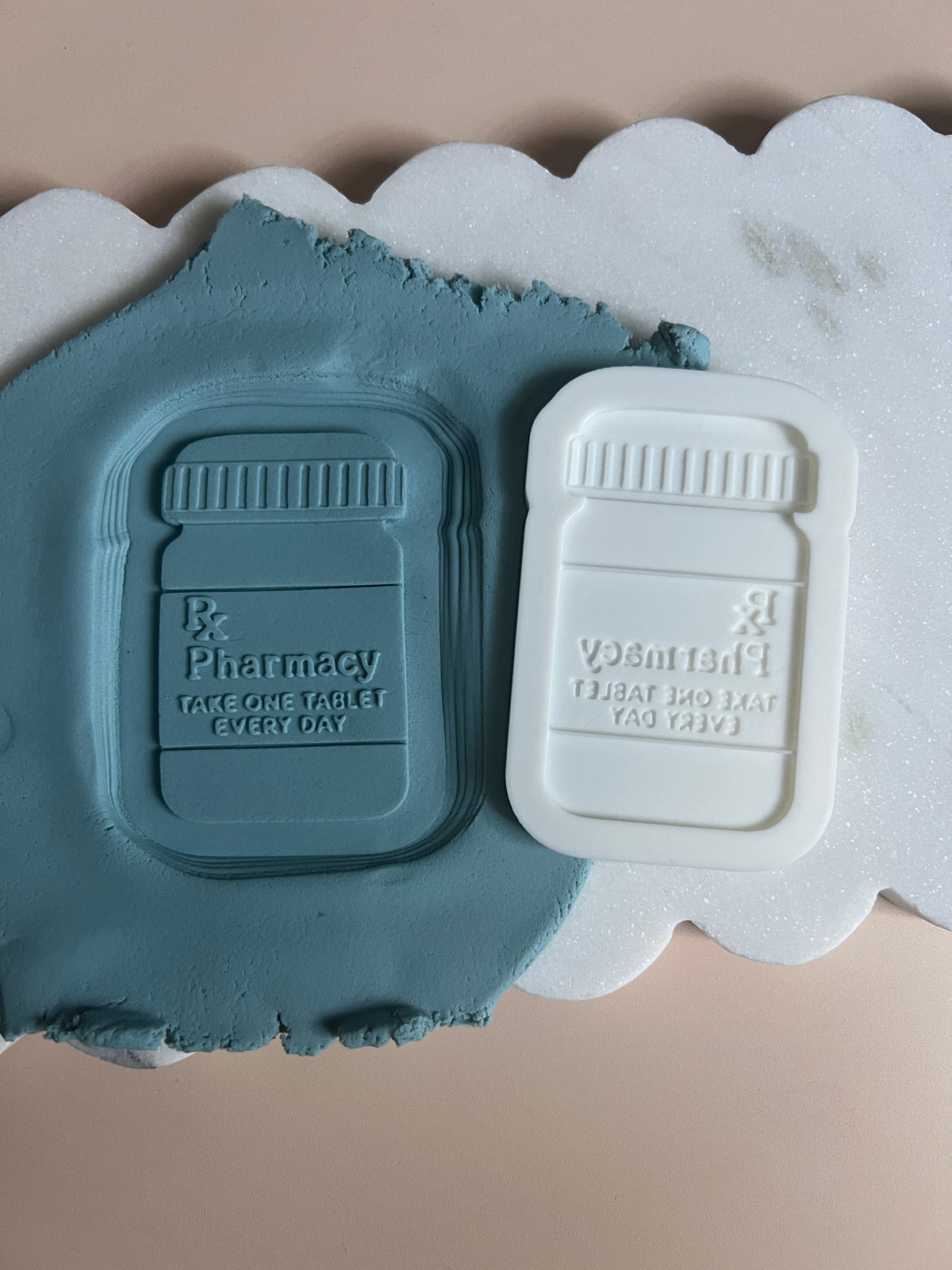 Pill bottle debosser and cutter