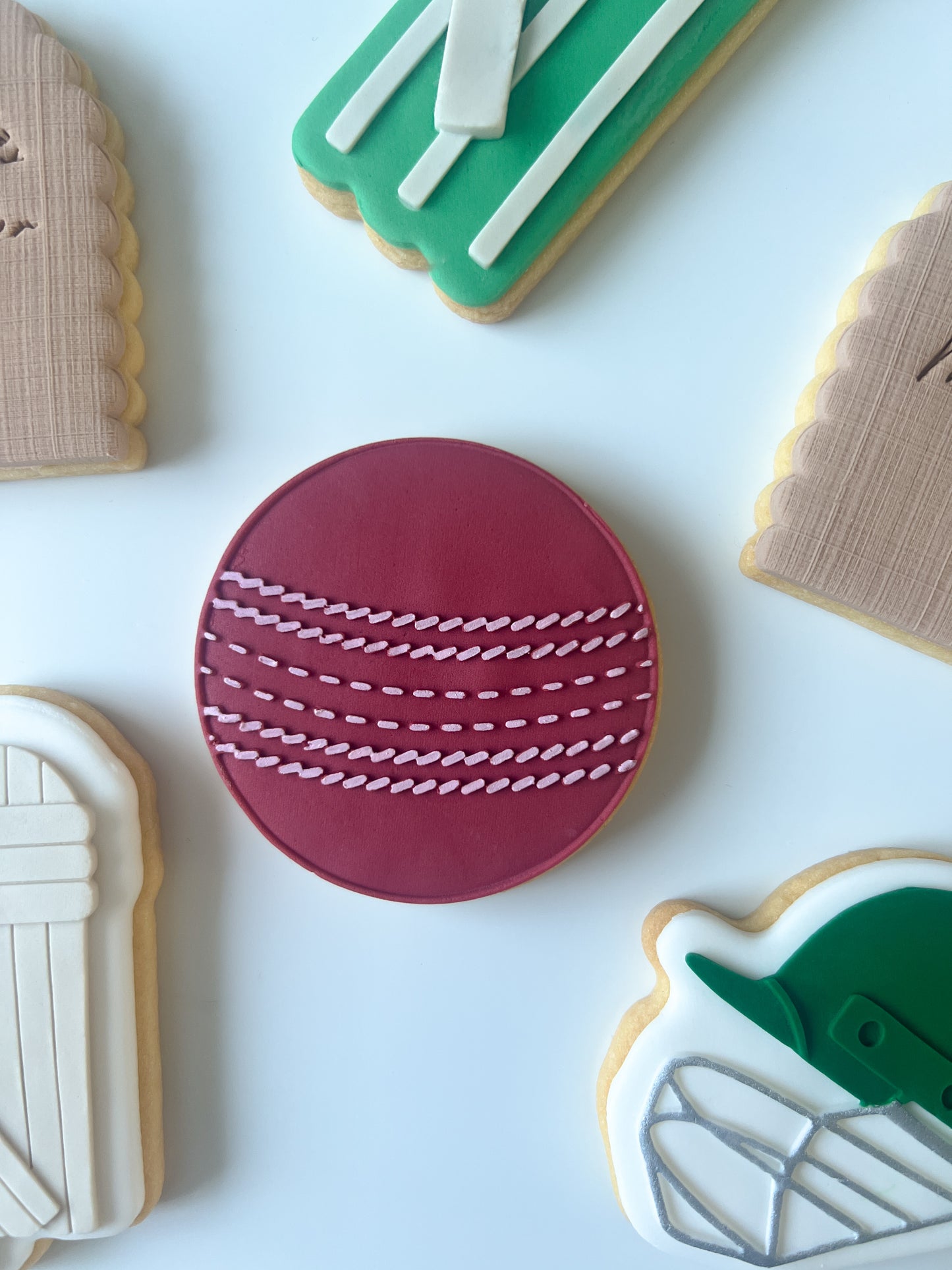 Cricket ball debosser and cutter