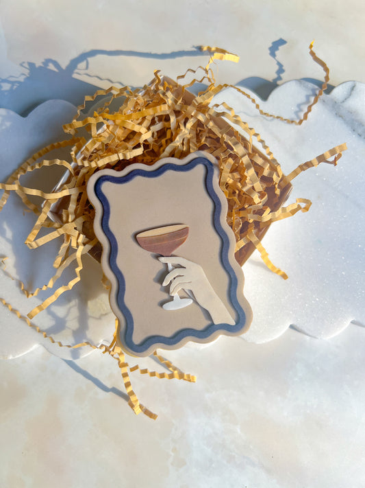 Hand holding martini stamp and cutter
