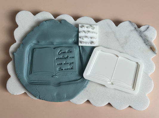 Open book with quote stamp and cutter