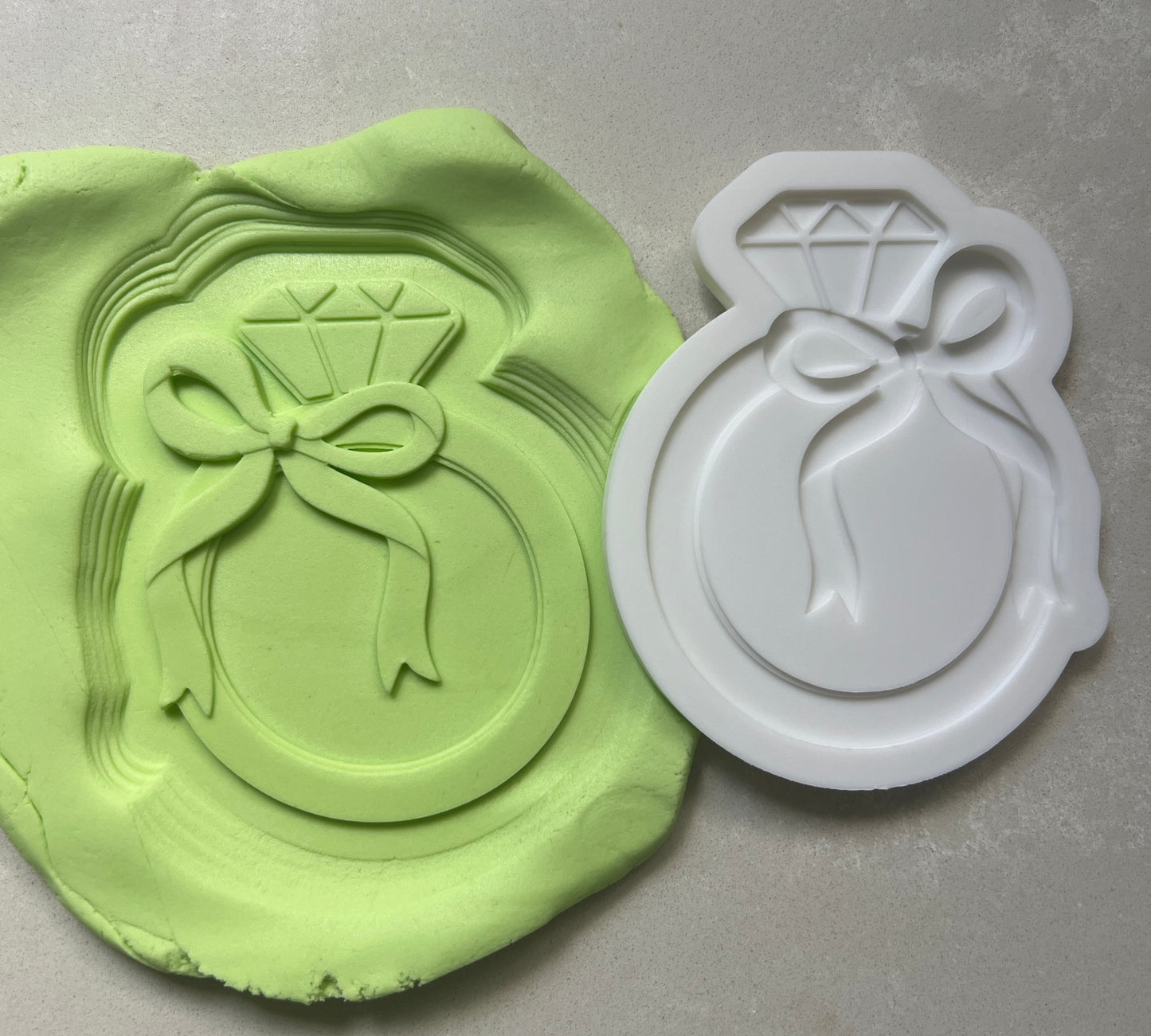 Ring with bow stamp and cutter