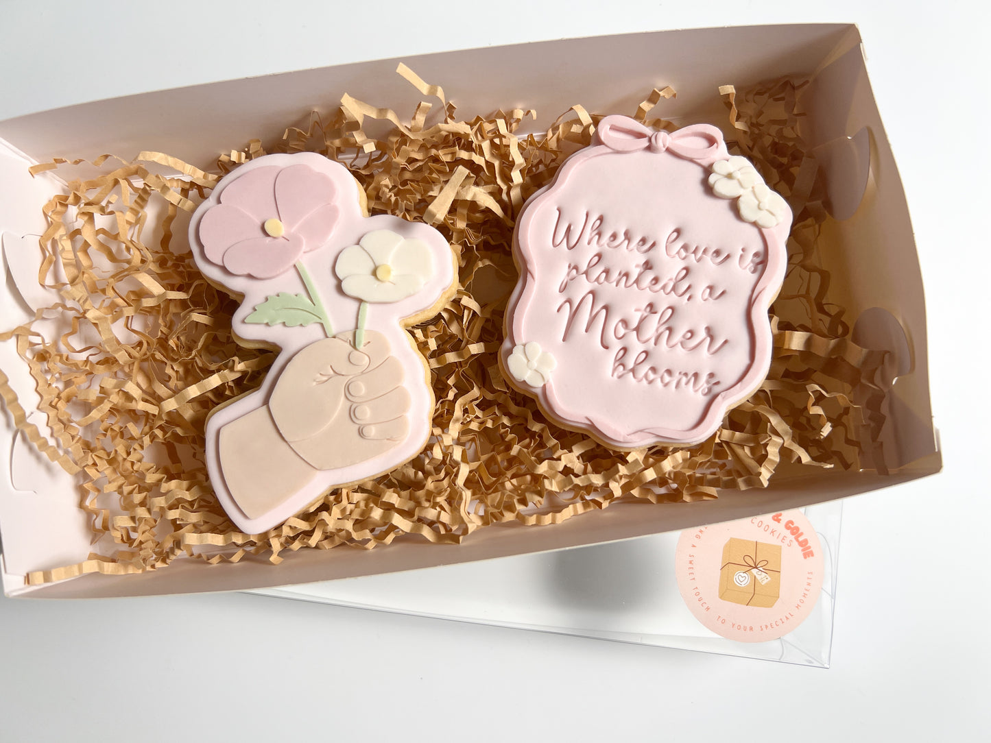 Child's hand holding flowers debosser and cutter
